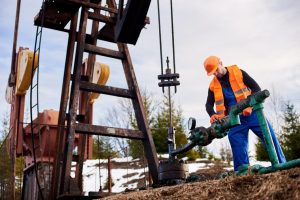 imgi_60_oil-worker-orange-uniform-helmet-working-with-pipe-wrench-near-oil-pump-jack_651396-2146